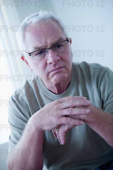 Portrait of sad senior man wearing spectacles. Photo : Rob Lewine