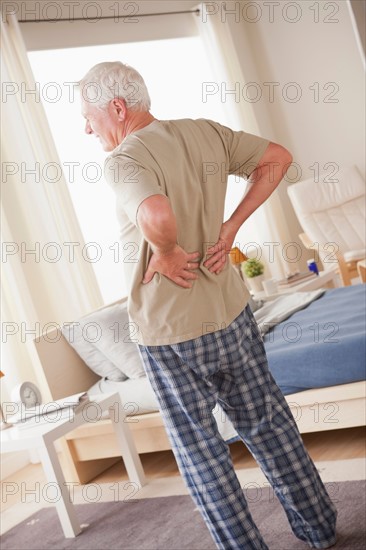 Senior man having backpain. Photo : Rob Lewine