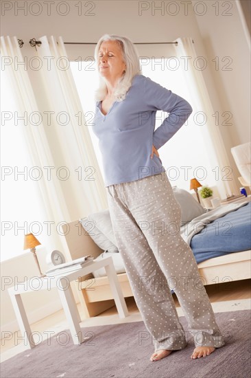 Senior woman having backpain. Photo : Rob Lewine
