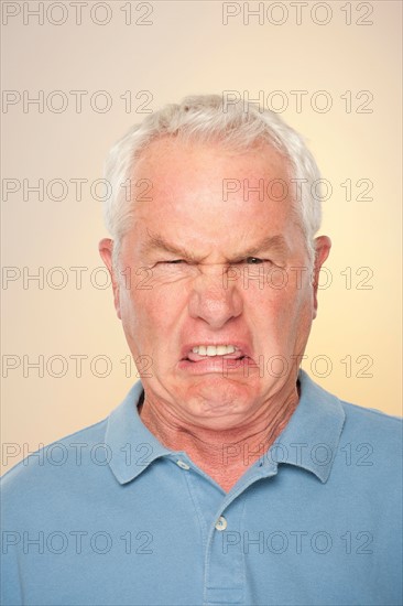 Portrait of senior man with disgusted face expression. Photo : Rob Lewine