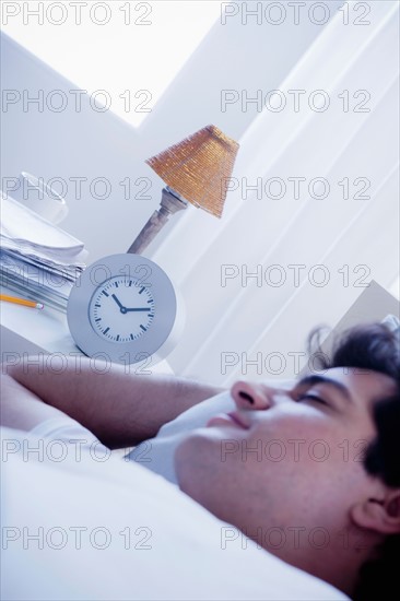 Young man sleeping in bed. Photo: Rob Lewine