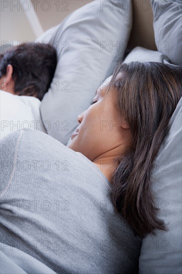 Couple sleeping in bed. Photo : Rob Lewine