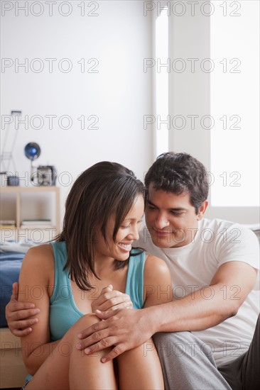 Couple cuddling at home. Photo: Rob Lewine