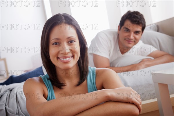 Portrait of mid adult couple in bedroom. Photo : Rob Lewine