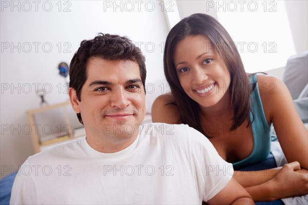 Portrait of mid adult couple in bedroom. Photo : Rob Lewine