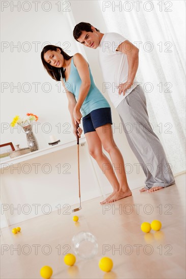 Couple playing mini golf at home. Photo : Rob Lewine