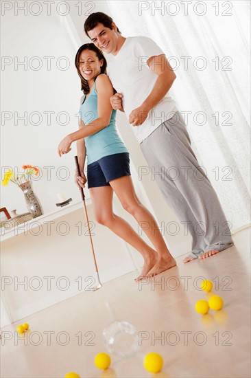 Couple playing mini golf at home. Photo : Rob Lewine
