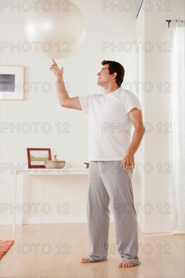 Man exercising with fitness ball. Photo : Rob Lewine