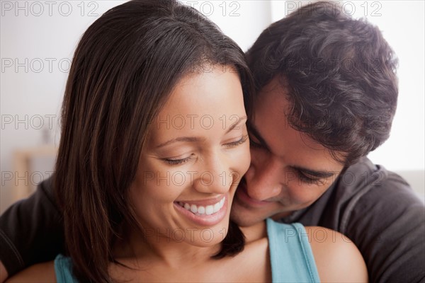 Smiling couple in close embrace. Photo : Rob Lewine