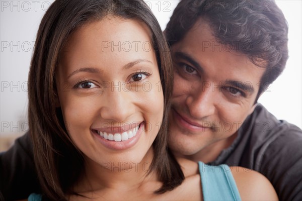 Smiling couple in close embrace. Photo : Rob Lewine