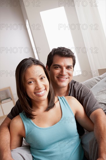 Smiling couple in close embrace. Photo : Rob Lewine