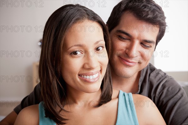 Smiling couple in close embrace. Photo : Rob Lewine