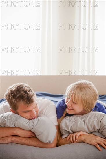 Couple lying in bed. Photo : Rob Lewine