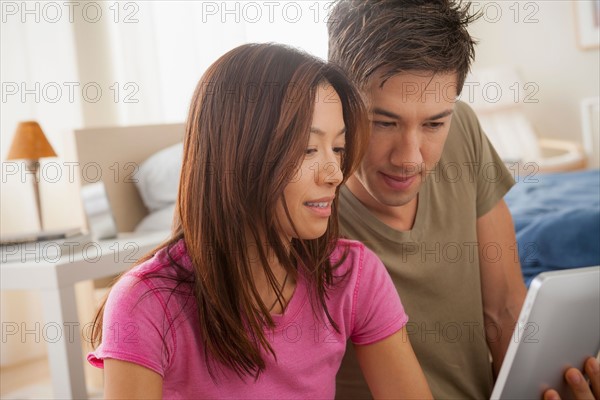 Couple using digital tablet. Photo : Rob Lewine