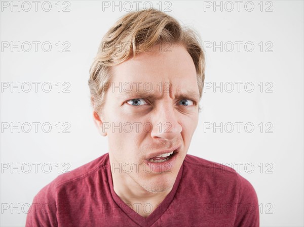 Studio Shot of mid adult man expressing anger. Photo : Jessica Peterson