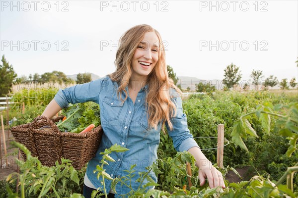 Portrait of young woman harvesting vegetables. Photo : Jessica Peterson