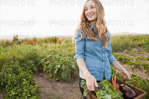 Portrait of young woman harvesting vegetables. Photo: Jessica Peterson