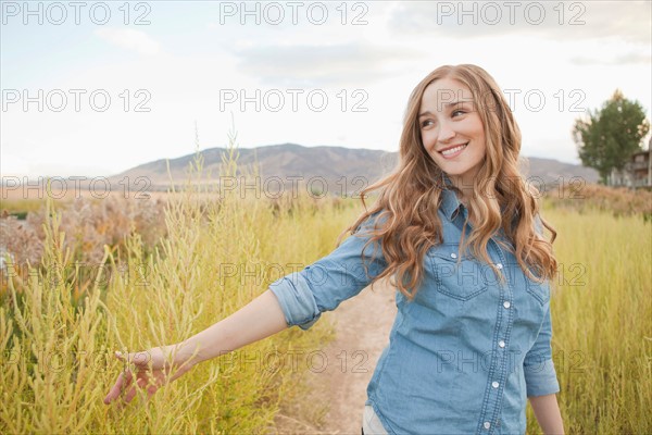 Portrait of young woman on dirt road. Photo : Jessica Peterson