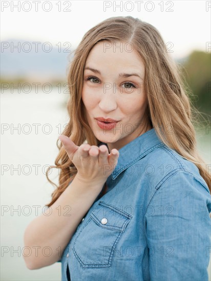 Portrait of young woman blowing kiss. Photo : Jessica Peterson