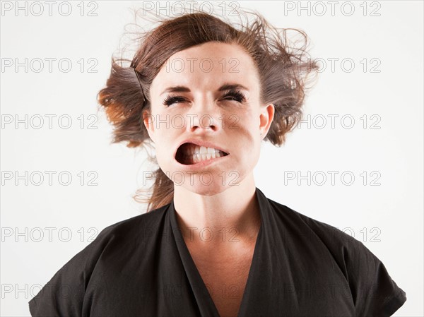 Studio portrait of young woman facing wind. Photo : Jessica Peterson