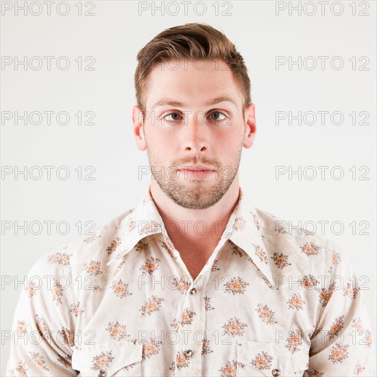 Studio portrait of cross-eyed man. Photo : Jessica Peterson