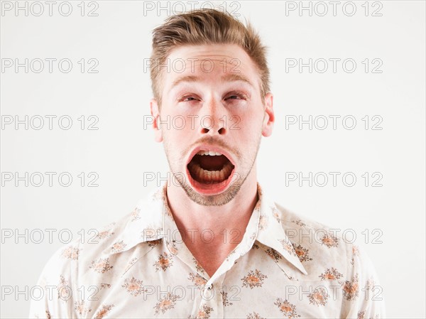 Studio shot of man with windblown mouth. Photo : Jessica Peterson