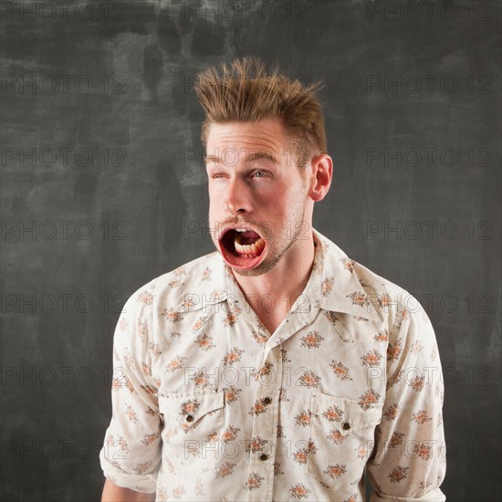 Studio shot of man with windblown mouth. Photo : Jessica Peterson