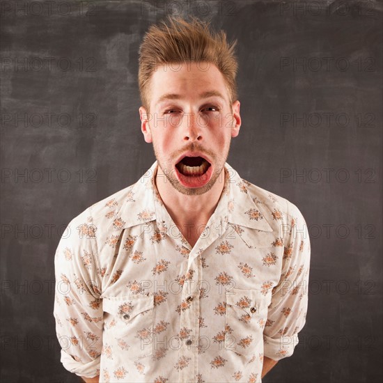 Studio shot of man with windblown mouth. Photo : Jessica Peterson