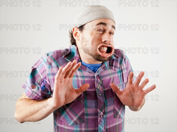 Studio shot of man with windblown mouth. Photo : Jessica Peterson