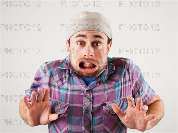 Studio shot of man with windblown mouth. Photo : Jessica Peterson