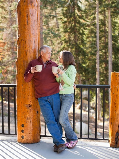 Couple drinking coffee on porch. Photo : Jessica Peterson