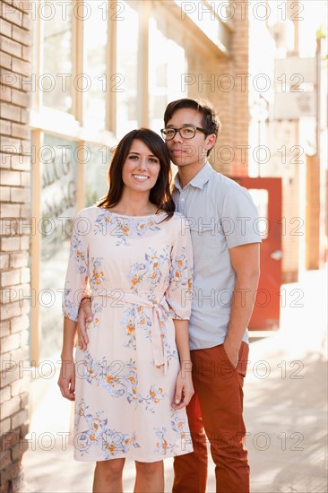 Portrait of couple standing on sidewalk. Photo: Jessica Peterson