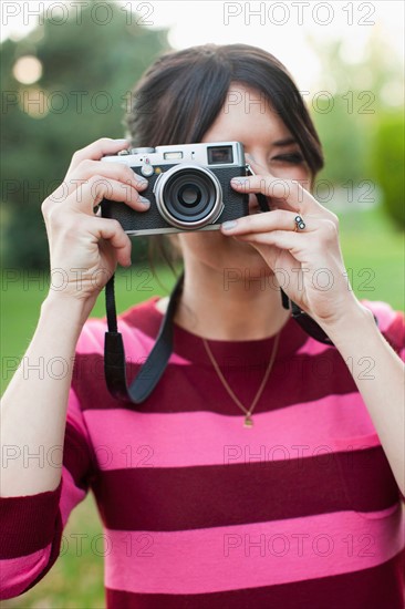 Woman using old camera. Photo : Jessica Peterson