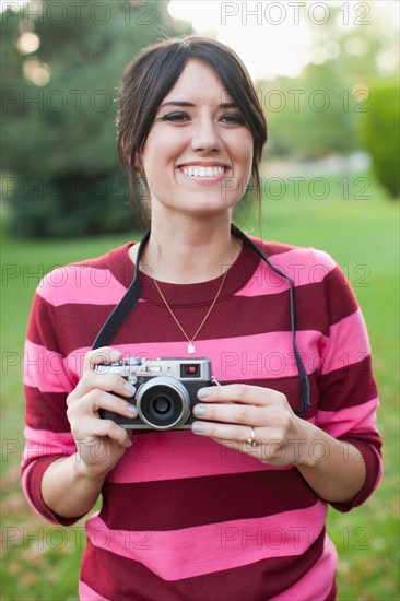 Woman using old camera. Photo : Jessica Peterson