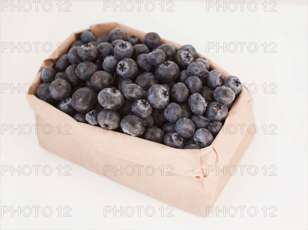 Carton of blueberries on white background. Photo: Jessica Peterson