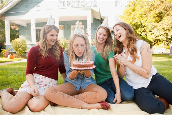 Young woman celebrating her birthday with friends. Photo: Jessica Peterson