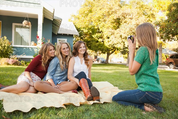 Young woman taking picture of her friends. Photo : Jessica Peterson