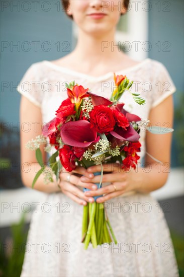 Mid section of bride with bouquet in focus. Photo: Jessica Peterson