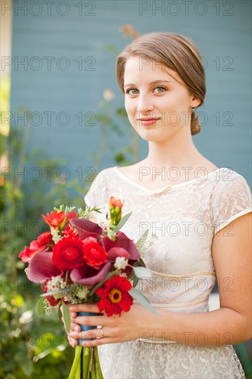 Portrait of bride holding bouquet. Photo: Jessica Peterson