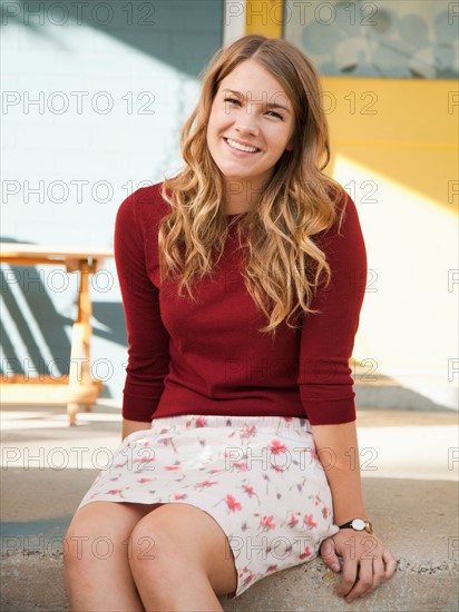 Portrait of young woman sitting on porch. Photo: Jessica Peterson