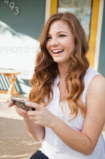 Portrait of young woman with her mobile phones. Photo : Jessica Peterson