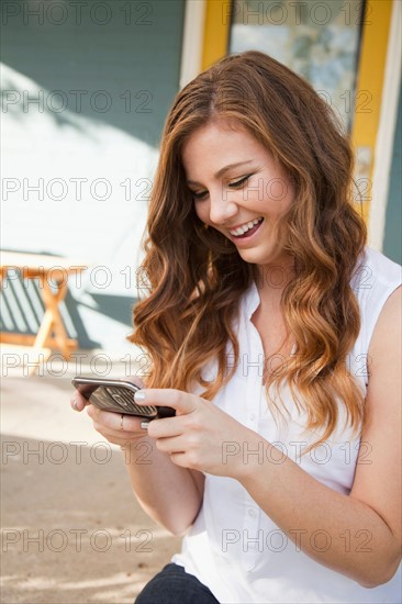 Portrait of young woman with her mobile phones. Photo : Jessica Peterson