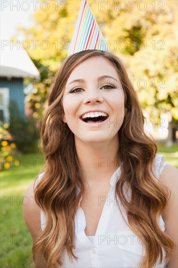 Portrait of young woman in party hat. Photo: Jessica Peterson