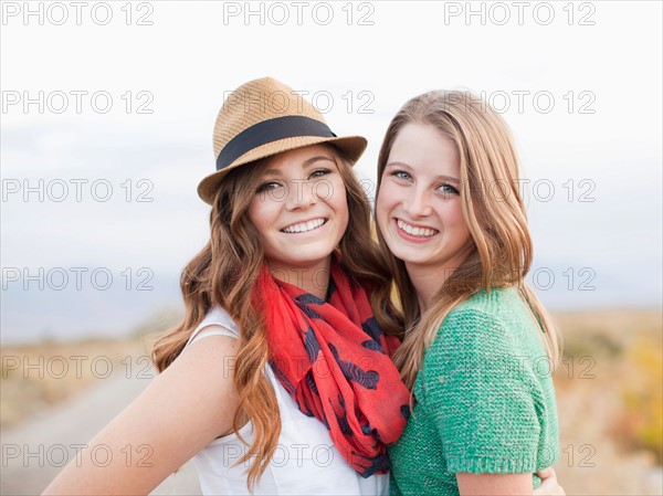 Portrait of two young women cheek to cheek. Photo : Jessica Peterson