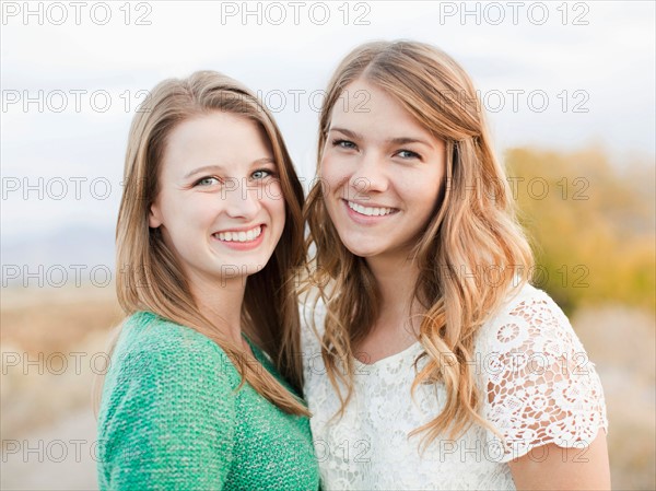 Portrait of two young women cheek to cheek. Photo : Jessica Peterson