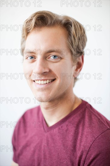 Studio Shot of young adult man expressing happiness. Photo: Jessica Peterson