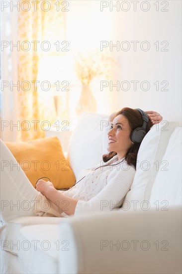 Woman listening to music at home.