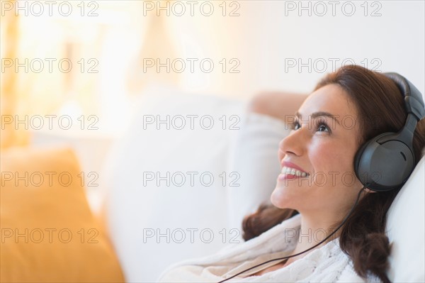 Woman listening to music at home.