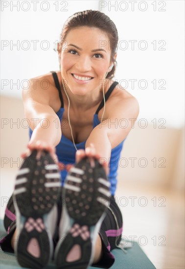 Portrait of woman stretching in gym.
