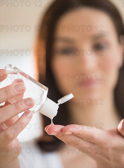 Woman using hand sanitizer.